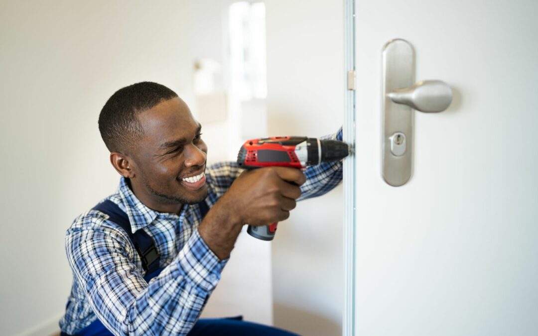 A reliable locksmith installs a door lock.