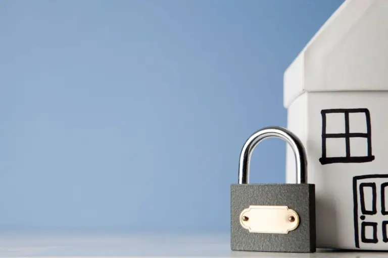 A small home next to a lock, symbolizing residential security