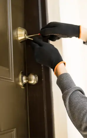 Residential locksmith performing door handle repair and adjustment service
